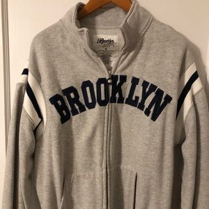 Varsity style full zip jersey sweater